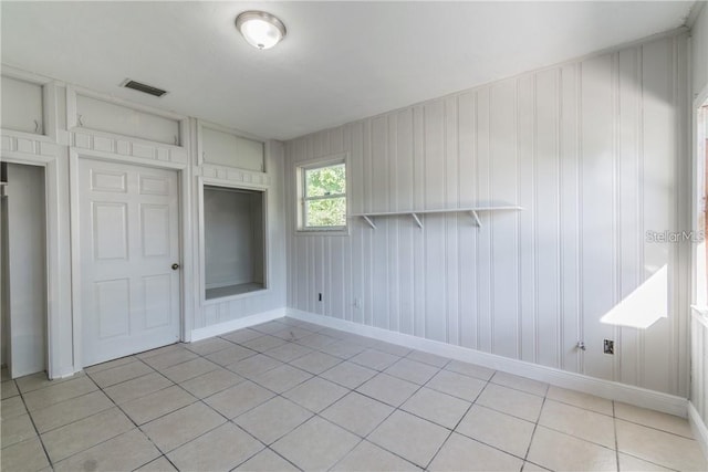 unfurnished bedroom with a closet and light tile patterned flooring