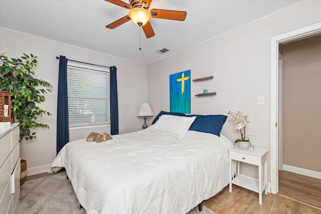 bedroom featuring light hardwood / wood-style flooring and ceiling fan