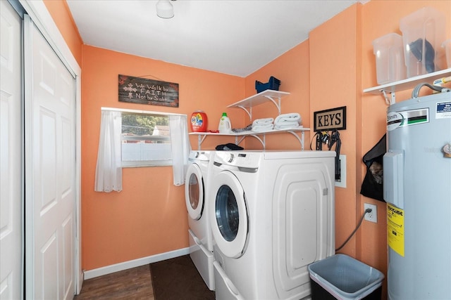 washroom with washing machine and dryer, dark wood-type flooring, and water heater