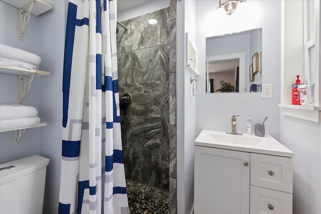 bathroom featuring vanity, curtained shower, and toilet