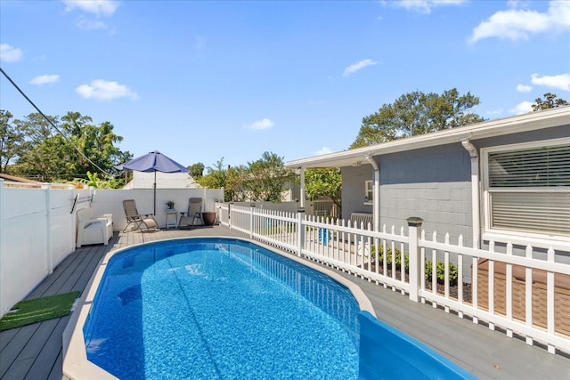 view of swimming pool featuring a wooden deck