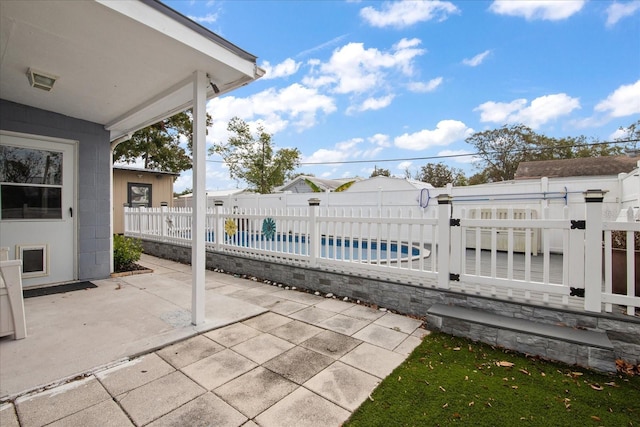 view of patio with a fenced in pool