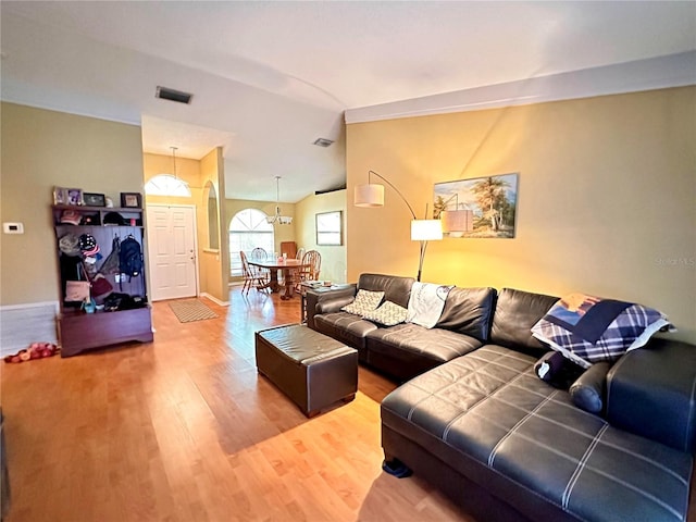 living room with hardwood / wood-style flooring and vaulted ceiling