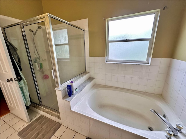 bathroom with tile patterned floors and shower with separate bathtub