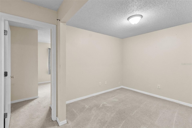 carpeted spare room featuring a textured ceiling