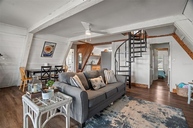 living room featuring ceiling fan, dark hardwood / wood-style flooring, plenty of natural light, and wooden walls