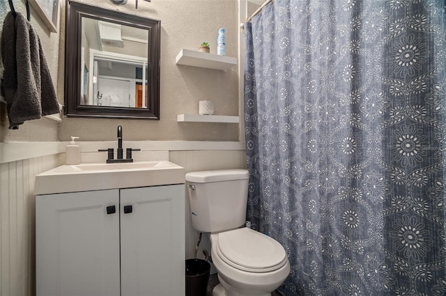 bathroom with vanity, toilet, and curtained shower