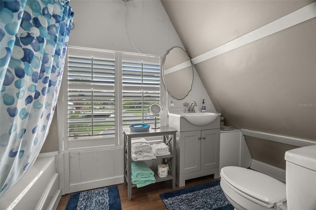 full bathroom featuring toilet, lofted ceiling, shower / tub combo with curtain, and vanity