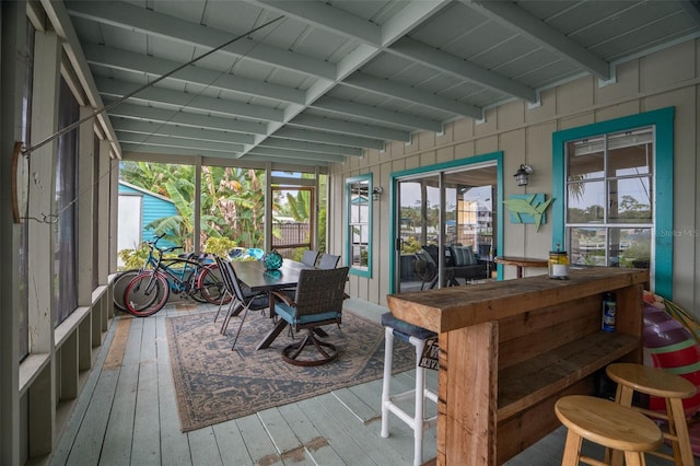 sunroom / solarium featuring a wealth of natural light and beam ceiling