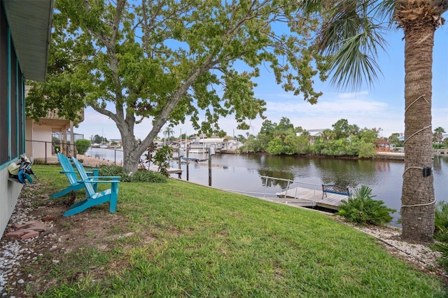 dock area featuring a yard and a water view