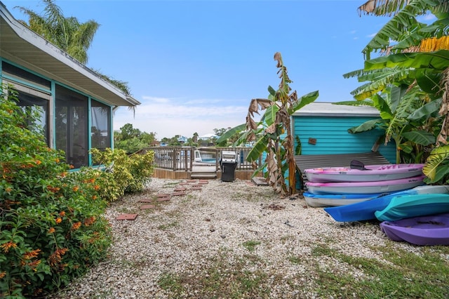 view of yard with a sunroom and a deck