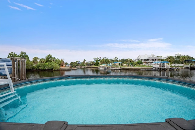 view of swimming pool with a water view