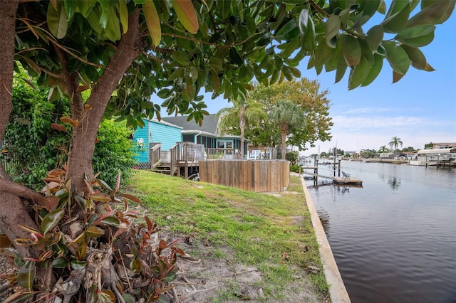 view of yard with a deck with water view