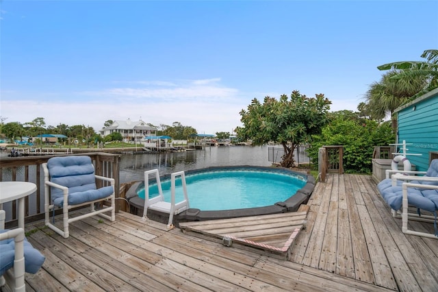 view of swimming pool with a deck with water view