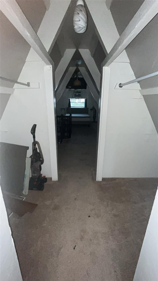 hallway featuring vaulted ceiling with beams