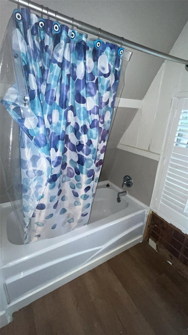 bathroom featuring shower / bath combination with curtain and hardwood / wood-style flooring