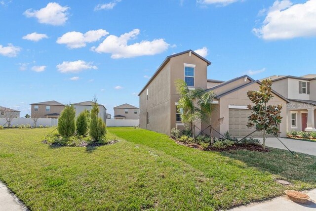 view of front of property with a front yard and a garage