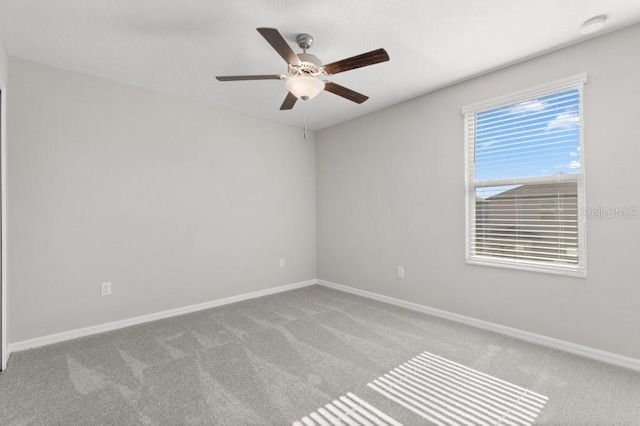 spare room featuring ceiling fan and light carpet