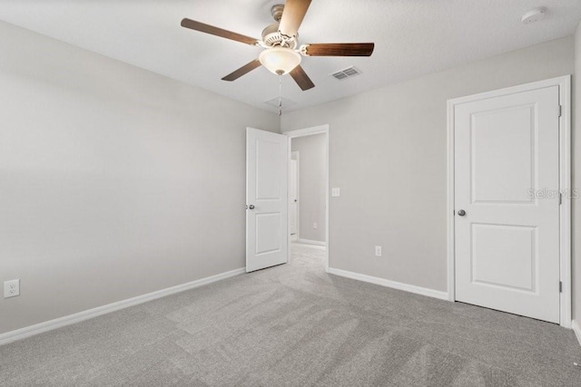 unfurnished bedroom with light carpet and ceiling fan