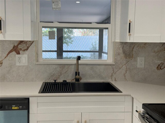 kitchen with white cabinets, dishwasher, and sink