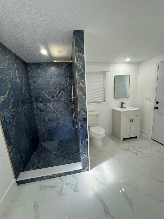 bathroom featuring tiled shower, a textured ceiling, vanity, and toilet