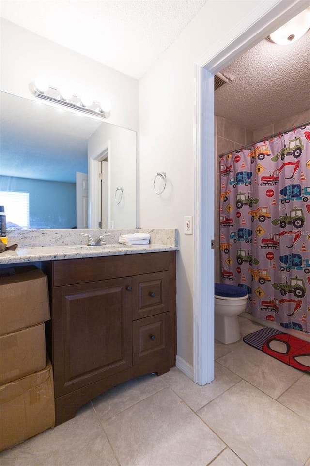 bathroom with a textured ceiling, vanity, tile patterned flooring, toilet, and a shower with curtain