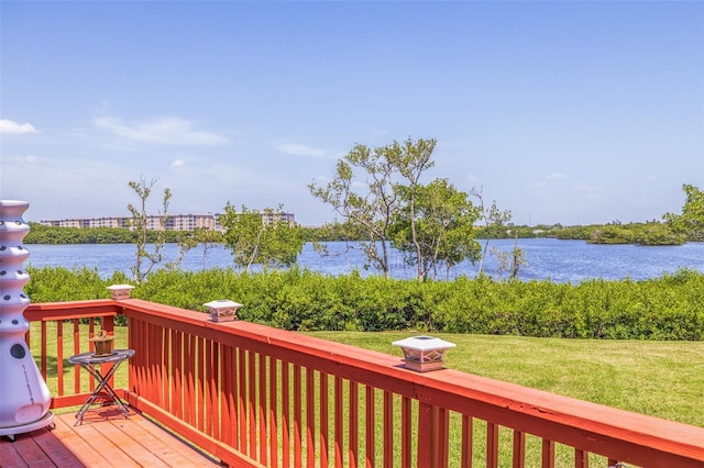 deck with a yard and a water view