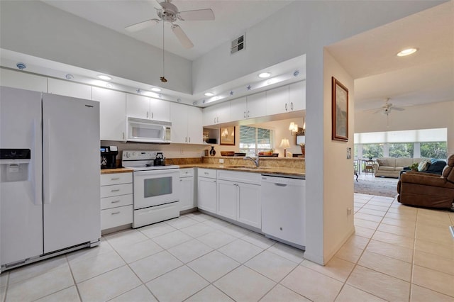 kitchen featuring white cabinets, light tile patterned floors, white appliances, sink, and ceiling fan