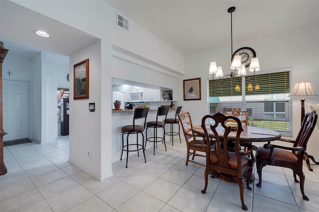 dining space featuring a chandelier and light tile patterned floors