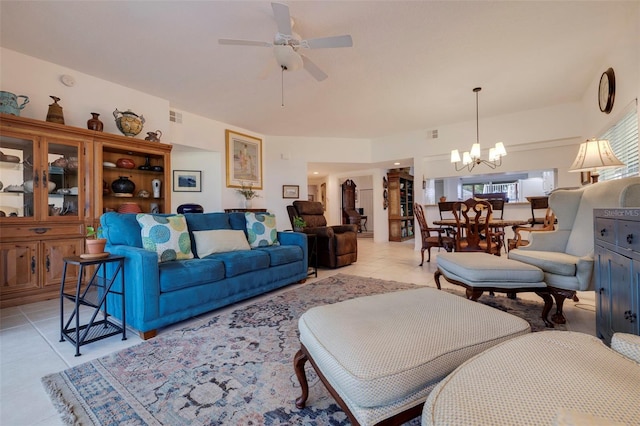 living room featuring light tile patterned floors and ceiling fan with notable chandelier