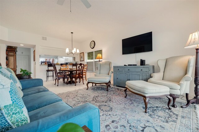 living room featuring ceiling fan with notable chandelier