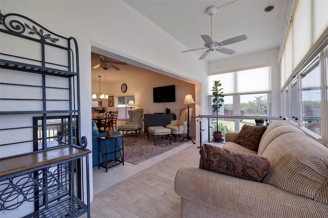 living room featuring a textured ceiling, light tile patterned flooring, and ceiling fan