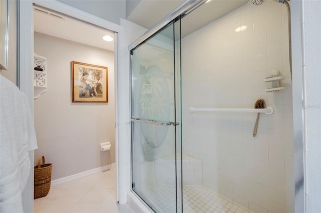 bathroom with tile patterned floors and walk in shower