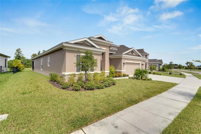 view of front of house featuring a garage and a front lawn