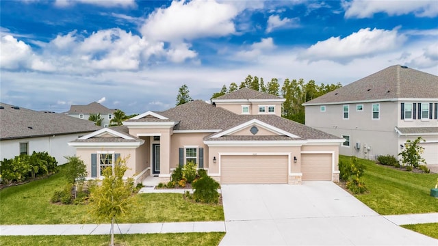 view of front of house featuring a garage and a front lawn