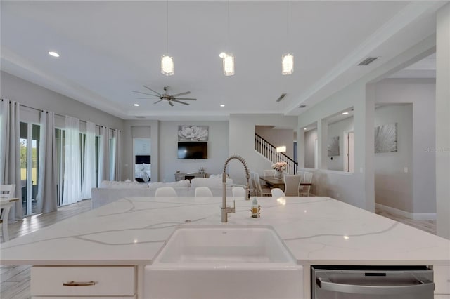 kitchen with pendant lighting, stainless steel dishwasher, sink, and ceiling fan