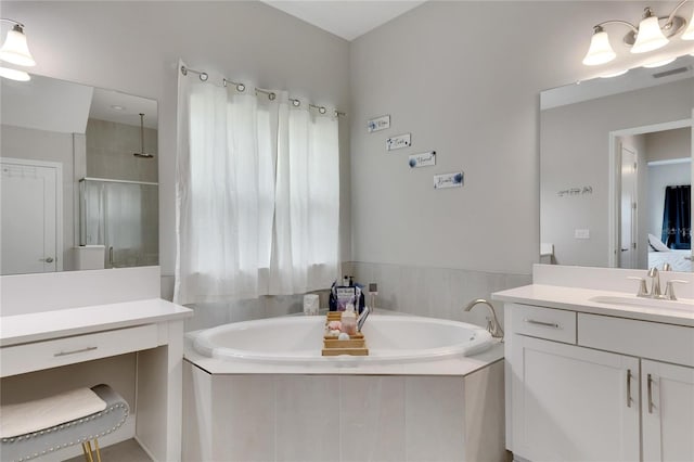 bathroom featuring vanity and independent shower and bath