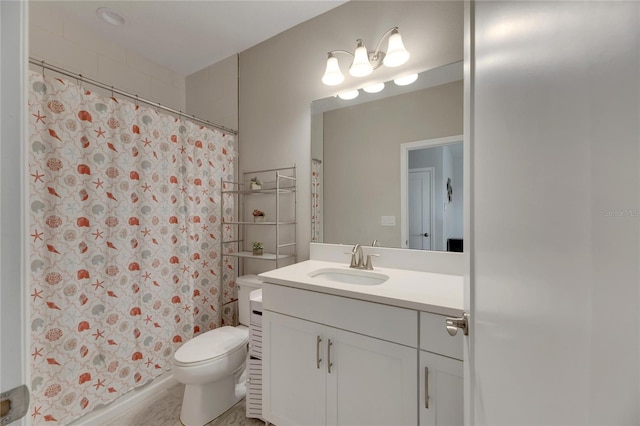 bathroom with vanity, toilet, and curtained shower