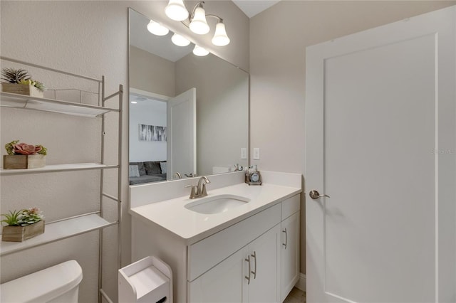 bathroom with toilet and vanity