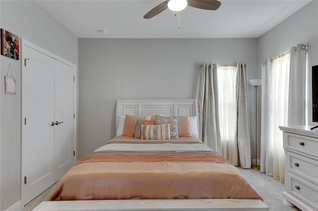 carpeted bedroom with a closet and ceiling fan