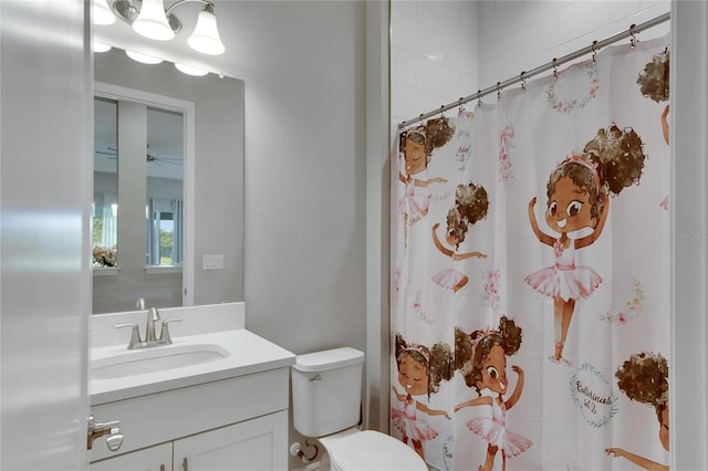 bathroom featuring vanity, toilet, and curtained shower