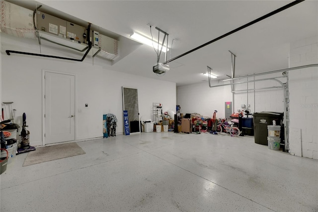 garage featuring electric panel and a garage door opener