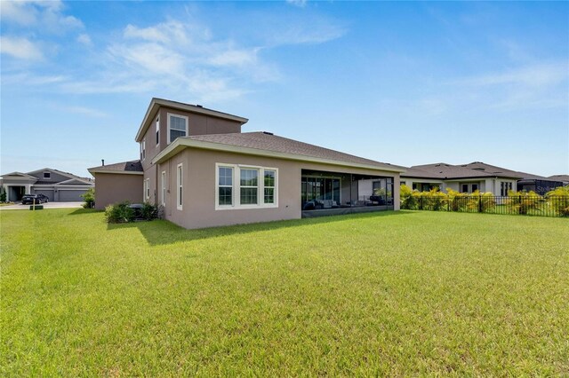 rear view of house with a lawn