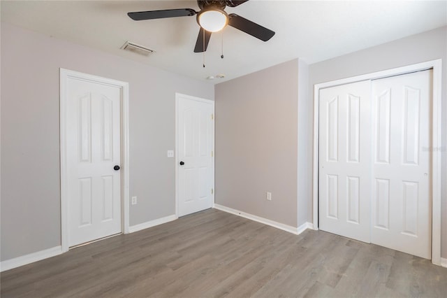 unfurnished bedroom with hardwood / wood-style floors and ceiling fan