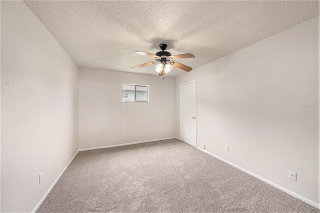 unfurnished room featuring ceiling fan, carpet floors, and a textured ceiling