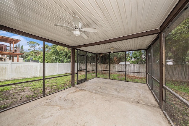 unfurnished sunroom with ceiling fan