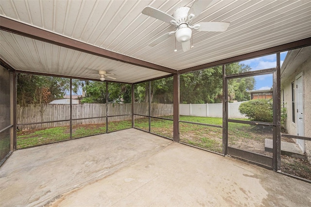 unfurnished sunroom featuring ceiling fan