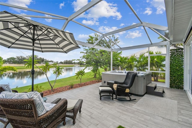 view of patio / terrace with a lanai, a water view, and a hot tub