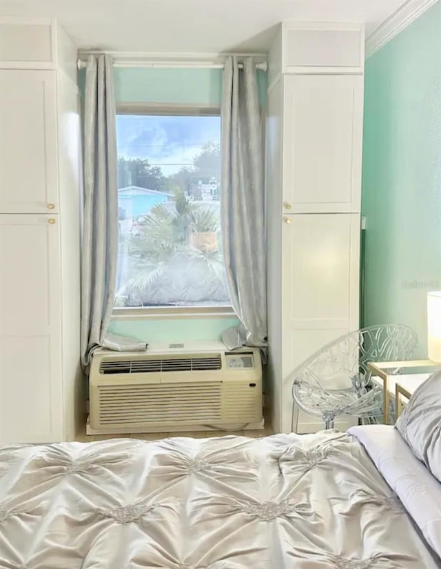 bedroom with cooling unit and ornamental molding