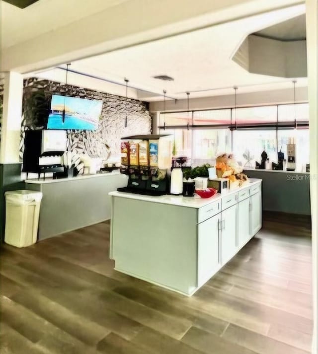 kitchen featuring wood finished floors and white cabinetry